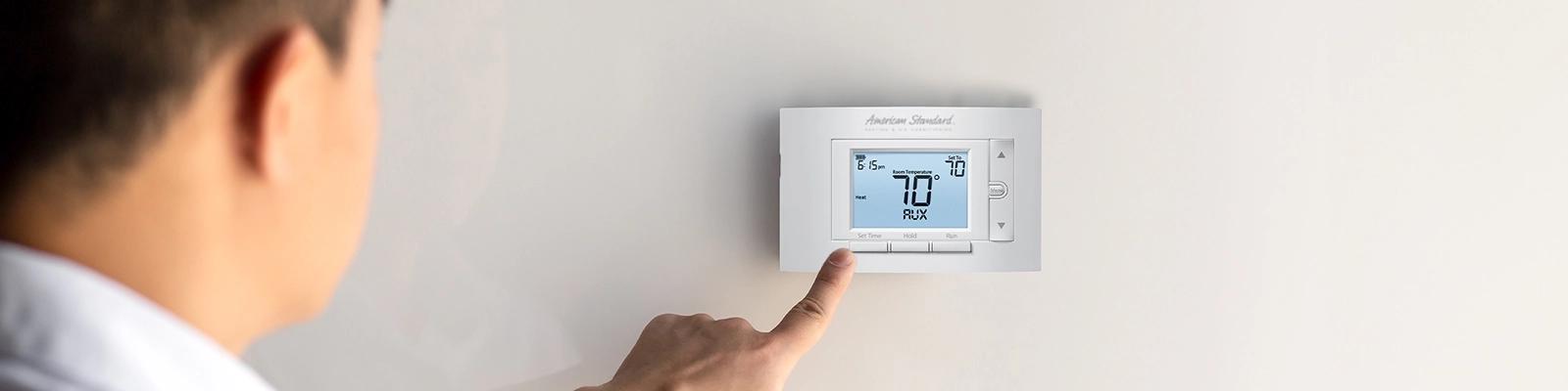 American Standard thermostat displaying AUX heat