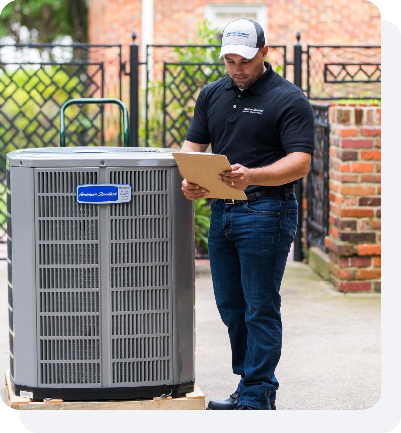 An HVAC technician inspecting a maintenance checklist on a clipboard.