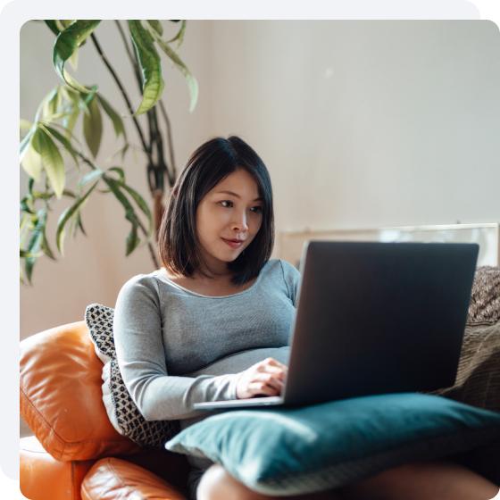 A woman researching HVAC warranties on her laptop.