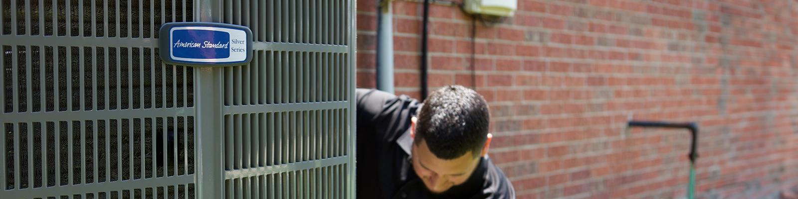 HVAC Technician Installing an American Standard Heat Pump